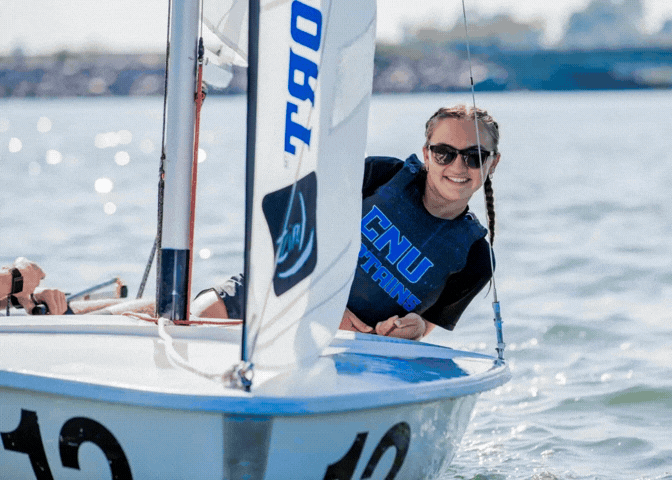 Photographs of a few of the sailing team members on the water in their boats