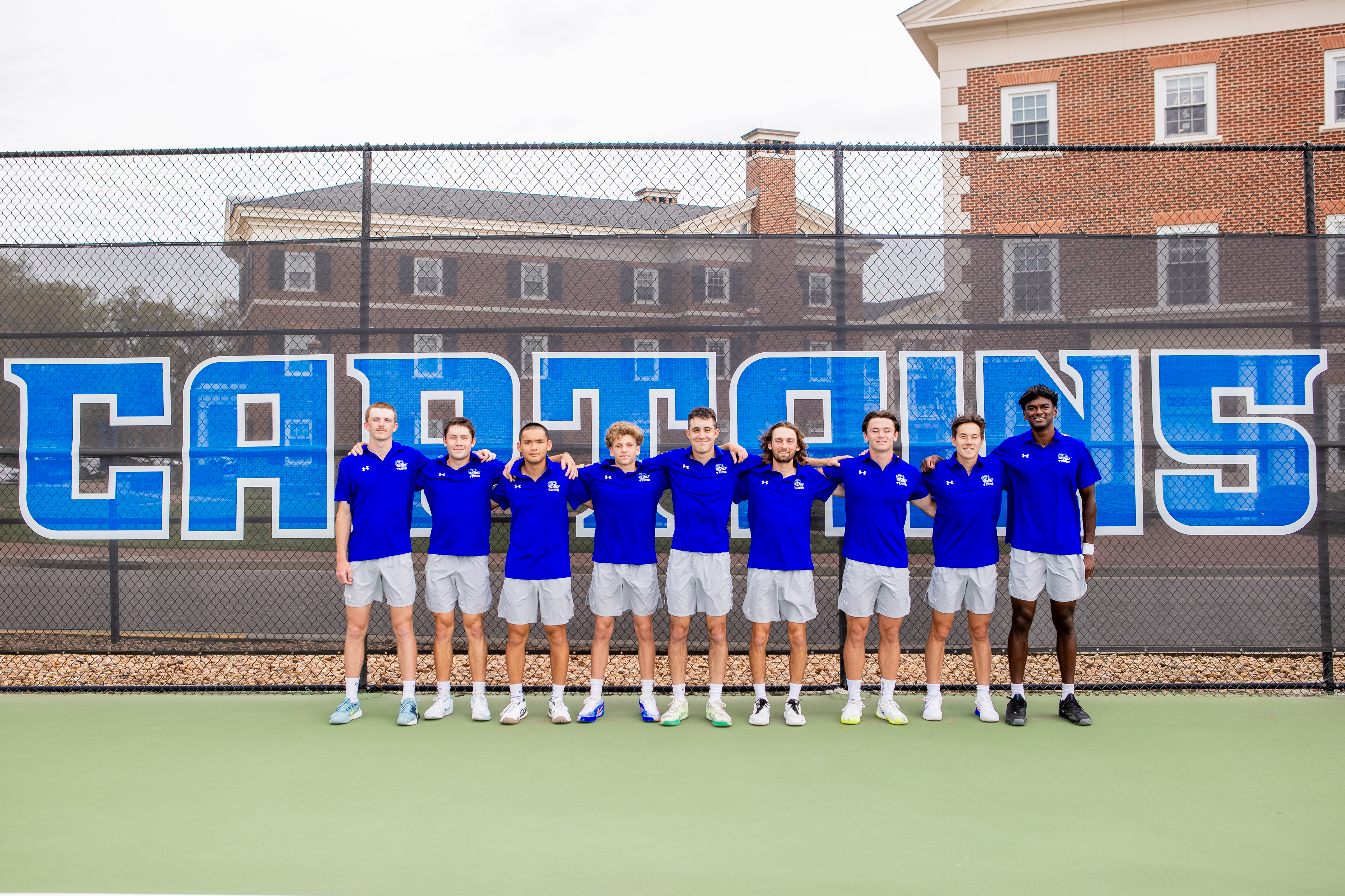 Photograph of the men's tennis team on the court