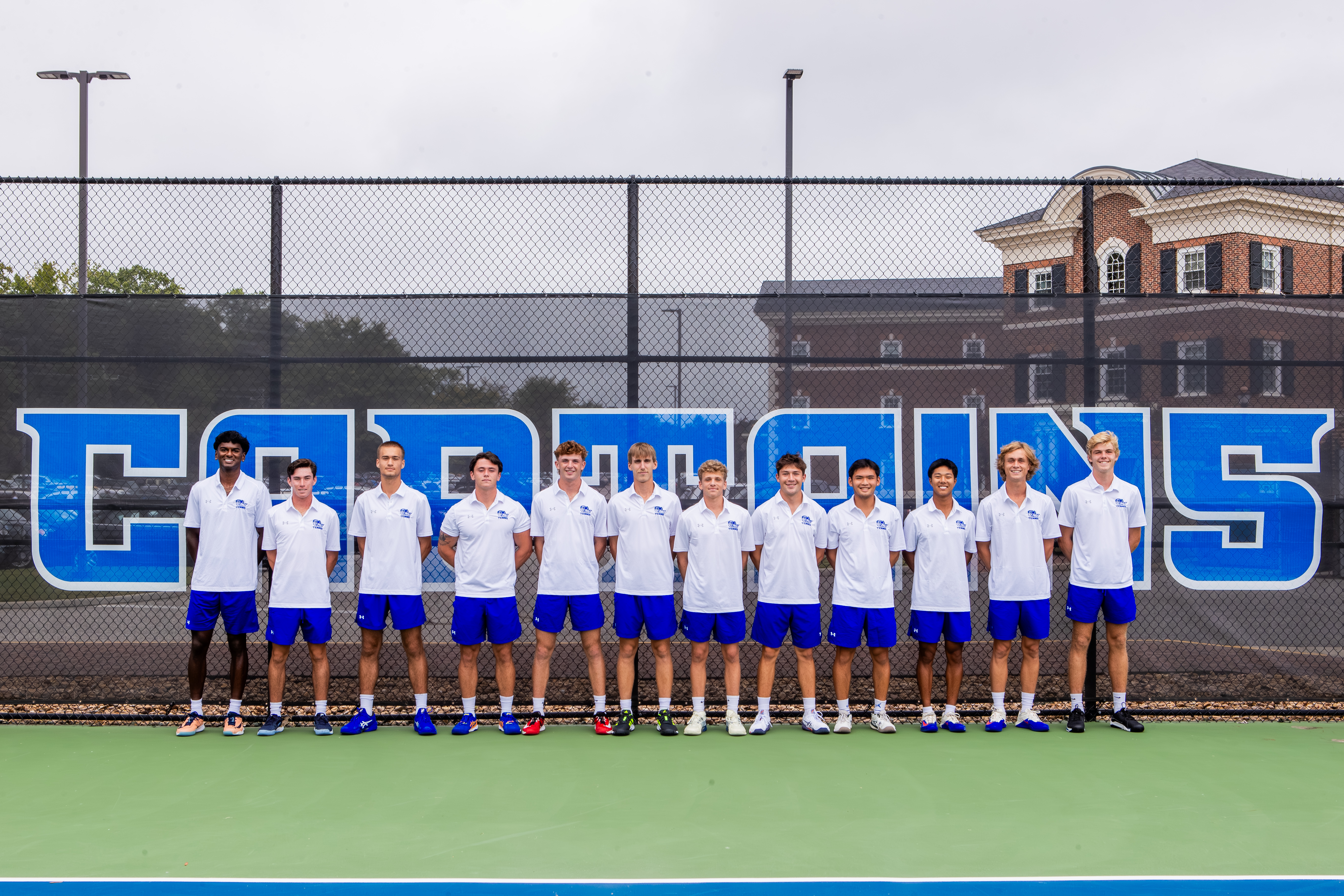 Photograph of the men's tennis team on the court