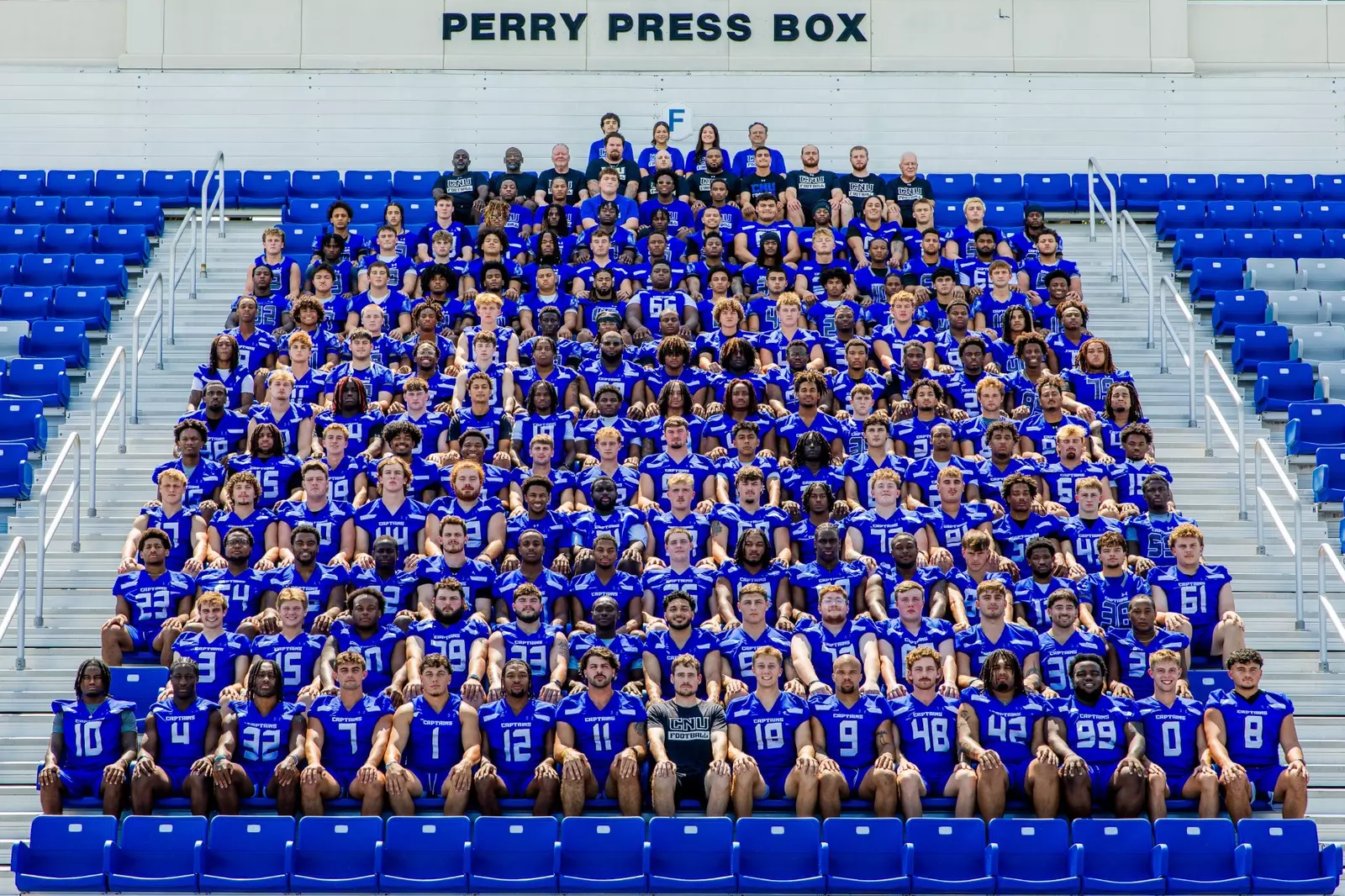 Photograph of the football team in the TownBank Stadium bleachers